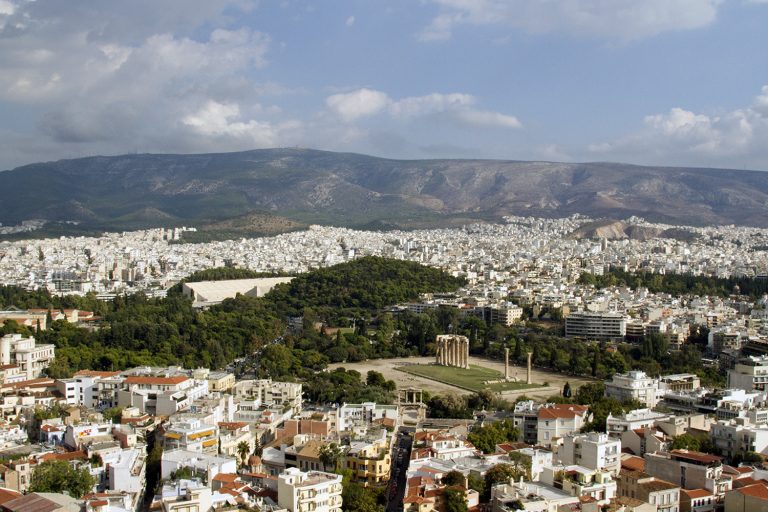 Looking out at the Temple of Olympian Zeus (Olympieio) from the Acropolis. Discover why Athens is worth visiting.