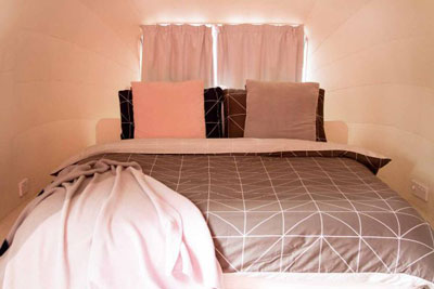 Close up of the pink and grey Hotel No in Melbourne bed. Find out what it's like to spend the night in airstream accommodation in Melbourne.