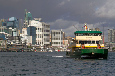 An iconic Sydney ferry, with the city skyline in the background. In an argument where Sydney vs. Melbourne, Sydney wins for public transport.