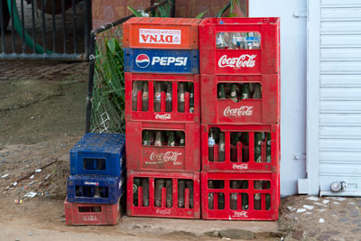 Crates of reusable glass Pepsi and Coca Cola bottles in Goa, India. Learn tips and tricks for travelling zero waste around the world.