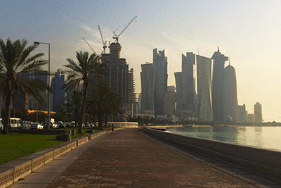 Walking the Corniche in Doha, early morning. Heading to Qatar in the future? Discover the best things to do in Doha, from desert adventures to fascinating cultural experiences.