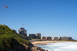 A glider drifts lazily over the scenic coastline of Newcastle. Discover the best beaches in Newcastle and Lake Macquarie.