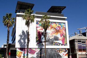 'She Imagined Buttons' (2020) by Jasmine Crisp, a mural of musician Sia Fuller painted on the side of the Rockford Hotel in Adelaide. It depicts Sia in a black dress, surrounded by colourful buttons. The mural is part of the Adelaide City of Music Laneways project.