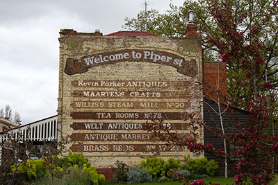 Piper Street ghost sign in Kyneton, advertising the addresses of businesses that used to be on the street. Visiting Piper St is one of the best things to do in Kyneton.
